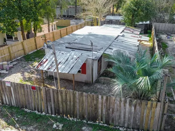 a view of a yard with wooden fence