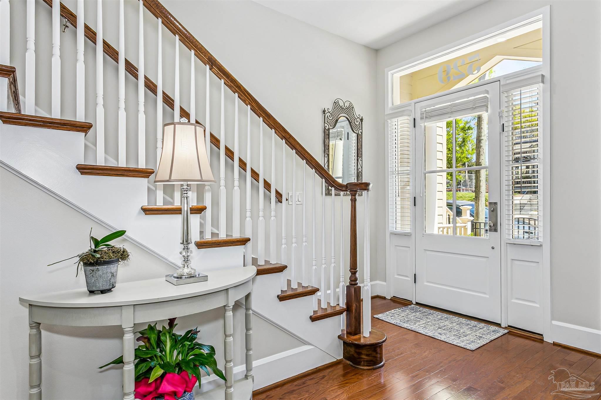 a view of entryway and hall with wooden floor