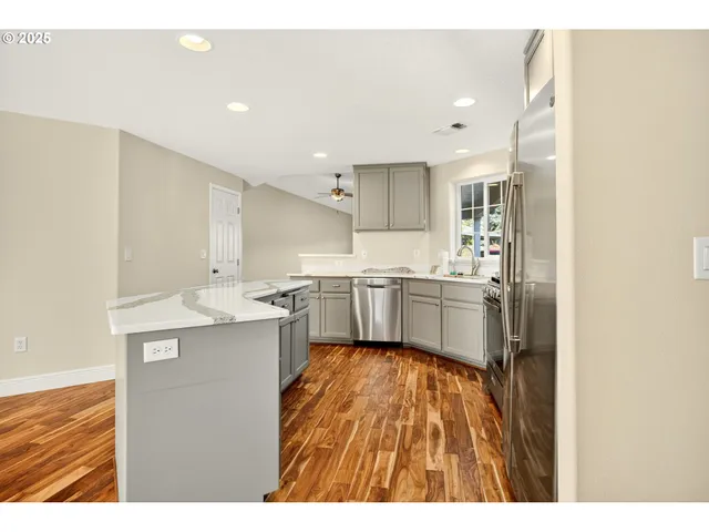 a kitchen with a sink window and cabinets