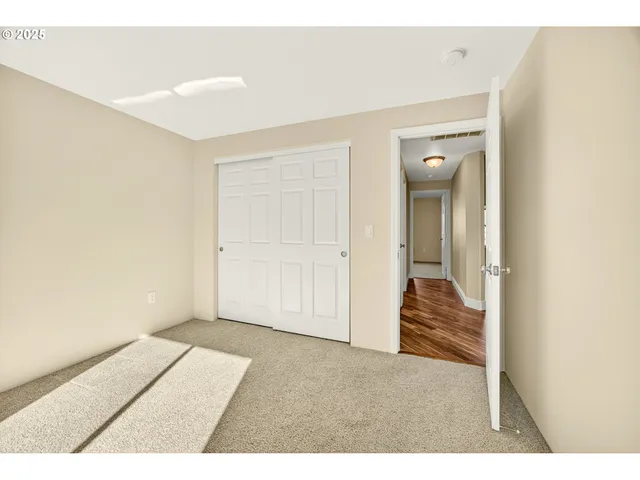 a bathroom with a granite countertop sink toilet and mirror