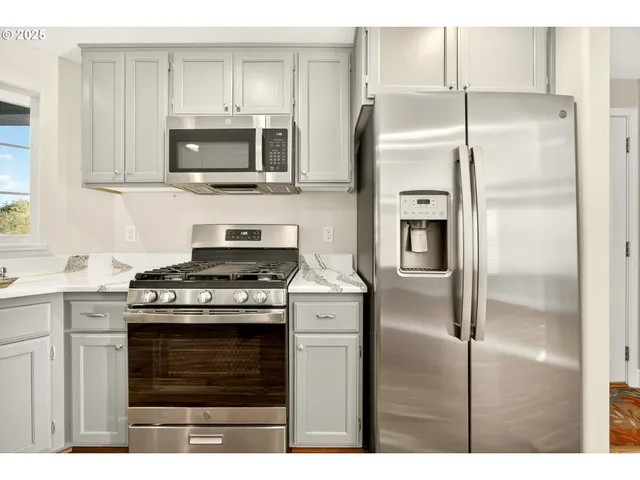 a kitchen with a stove microwave and refrigerator