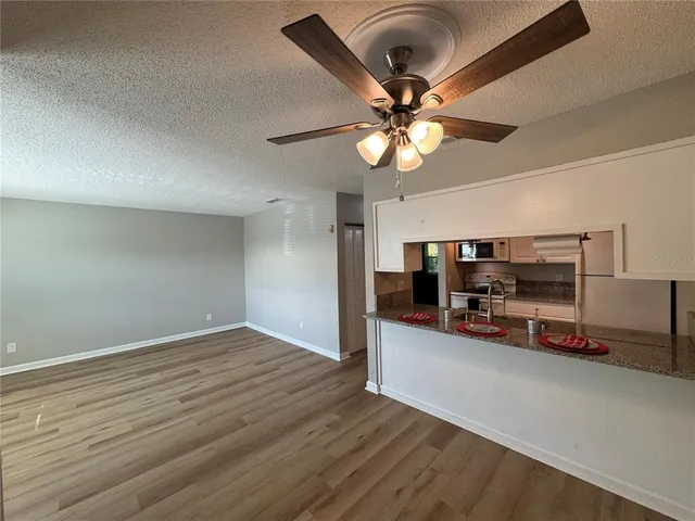 a kitchen with stainless steel appliances granite countertop a stove microwave and refrigerator