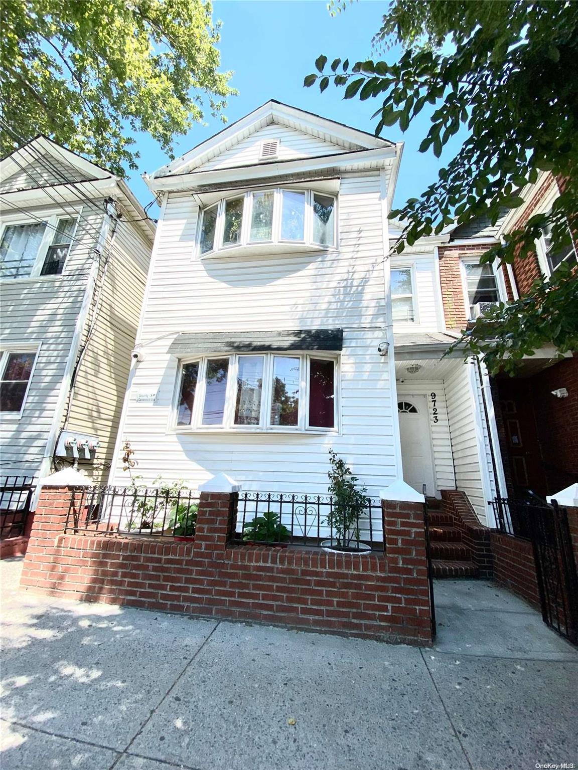 97-23 Alstyne Avenue Queens, NY 11368 - Photo 1 of 1 a front view of a house with a yard