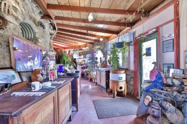 a patio with table and chairs and potted plants