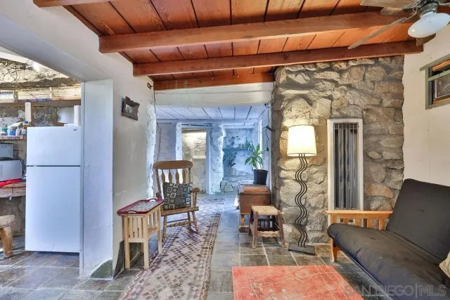 a living room with furniture and a painting on the wall