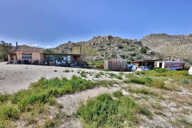 a view of balcony with table and chairs