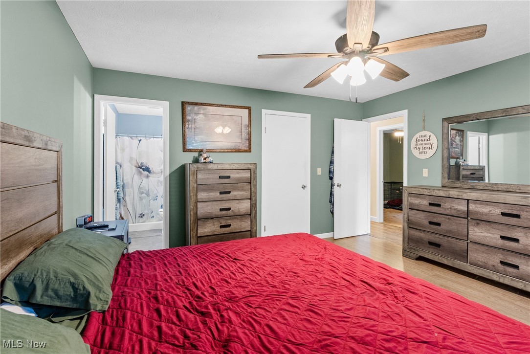 7944 Middle Ridge Road Madison, OH 44057 - Photo 17 of 31 Bedroom with light wood finished floors, ensuite bathroom, and a ceiling fan