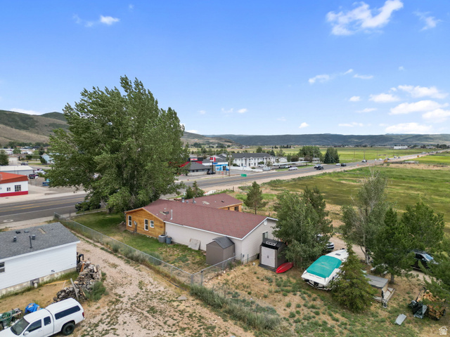 490 South Main Street Kamas, UT 84036 - Photo 21 of 25 Property featuring a wood-sided exterior, a red shingle roof, and an expansive lot