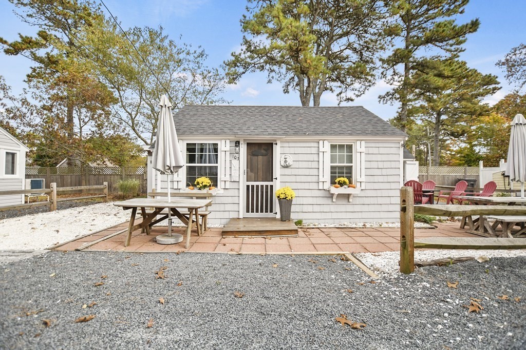262 Old Wharf Road, Unit 103 Dennis, MA 02639 - Photo 1 of 30 a view of a house with backyard and a tree