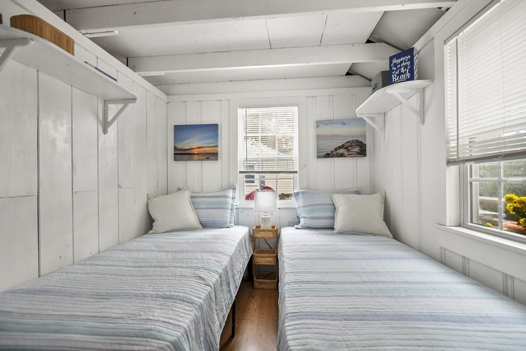 262 Old Wharf Road, Unit 103 Dennis, MA 02639 - Photo 12 of 30 a bedroom with a large bed and a window