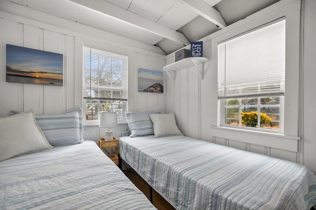 262 Old Wharf Road, Unit 103 Dennis, MA 02639 - Photo 13 of 30 a bedroom with a large bed and a window