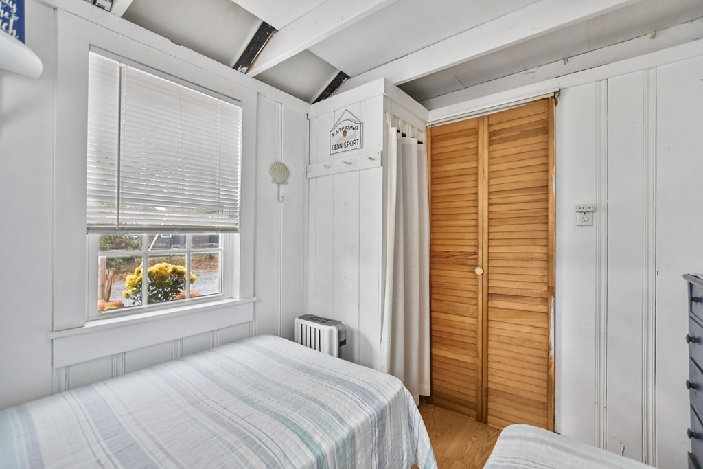 262 Old Wharf Road, Unit 103 Dennis, MA 02639 - Photo 14 of 30 a bedroom with a bed and a window with outer view