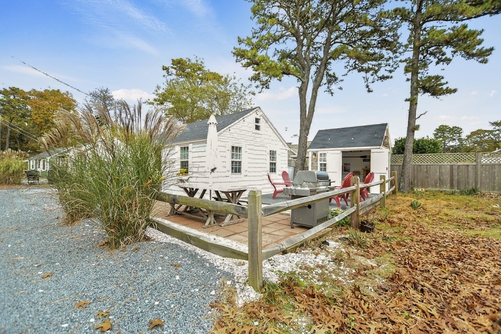 262 Old Wharf Road, Unit 103 Dennis, MA 02639 - Photo 21 of 30 a view of house with backyard and trees