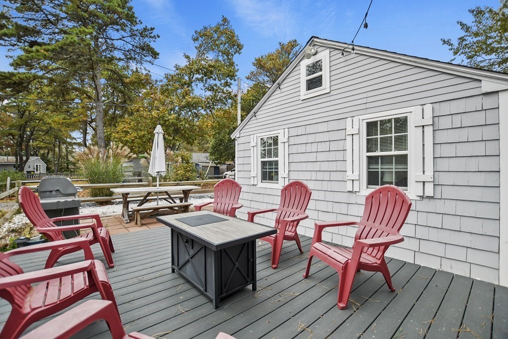 262 Old Wharf Road, Unit 103 Dennis, MA 02639 - Photo 25 of 30 a view of a patio with wooden floor and outdoor seating
