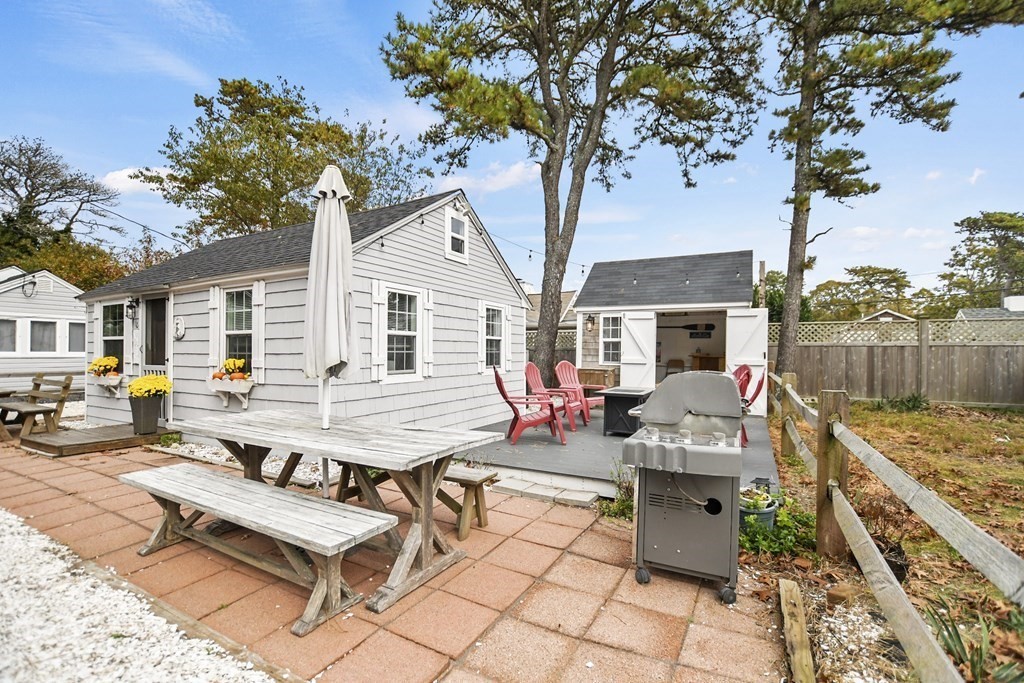 262 Old Wharf Road, Unit 103 Dennis, MA 02639 - Photo 5 of 30 a view of a patio with couches table and chairs under an umbrella