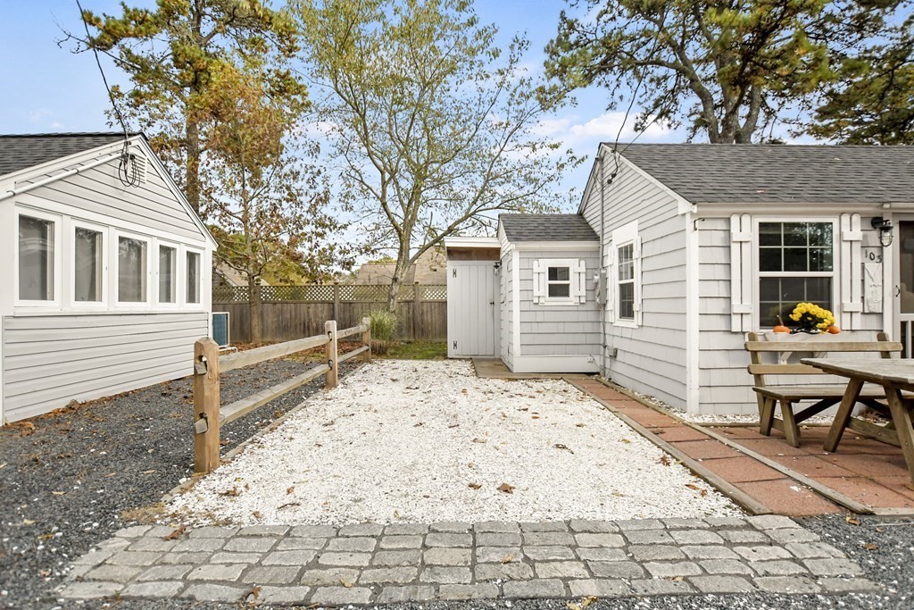 262 Old Wharf Road, Unit 103 Dennis, MA 02639 - Photo 6 of 30 a view of a house with a snow in the backyard