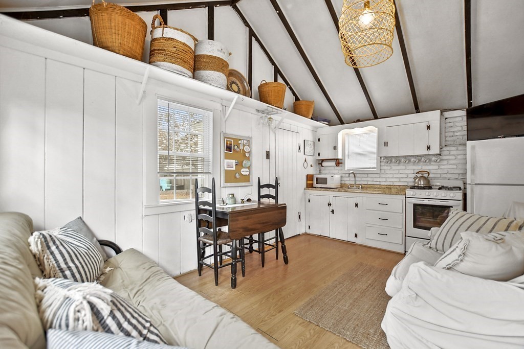 262 Old Wharf Road, Unit 103 Dennis, MA 02639 - Photo 7 of 30 a living room with furniture and kitchen view
