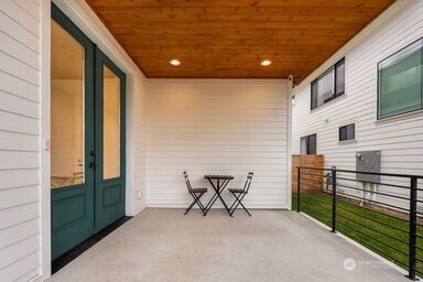 2411 Southwest 346th Street Federal Way, WA 98023 - Photo 2 of 30 a view of a patio with table and chairs and wooden floor