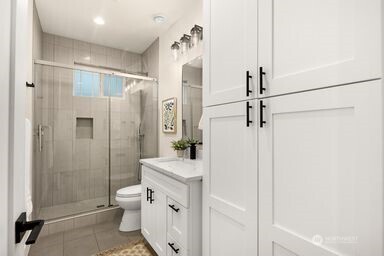 2411 Southwest 346th Street Federal Way, WA 98023 - Photo 5 of 30 a bathroom with a sink a toilet and shower