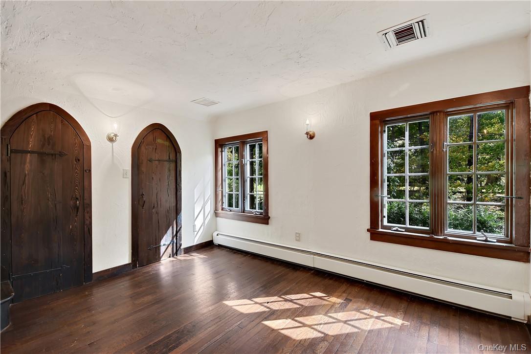 160 Long Ridge Road Bedford, NY 10506 - Photo 11 of 25 a view of an empty room with wooden floor and windows