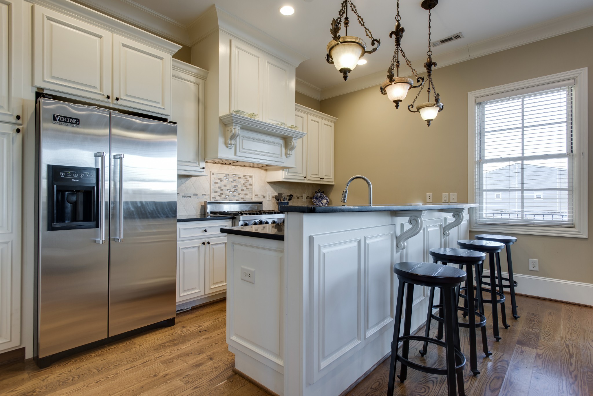 3127 Parthenon Avenue Nashville, TN 37203 - Photo 11 of 30 a kitchen with stainless steel appliances granite countertop a refrigerator a sink dishwasher a dining table and chairs with wooden floor