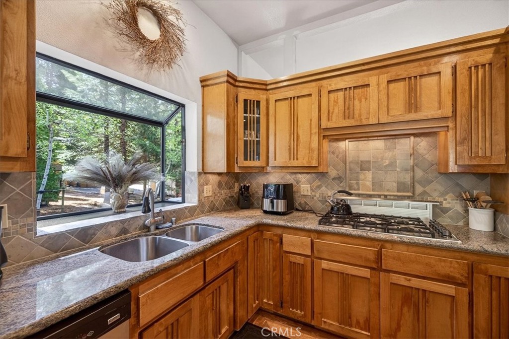 915 Golf Club Road Westwood, CA 96137 - Photo 22 of 67 a kitchen with granite countertop a sink and a window