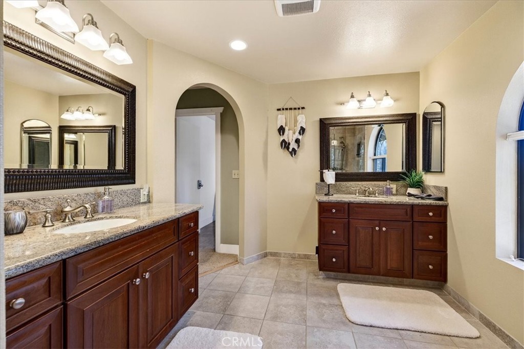 915 Golf Club Road Westwood, CA 96137 - Photo 32 of 67 a bathroom with a granite countertop double vanity sink and a mirror