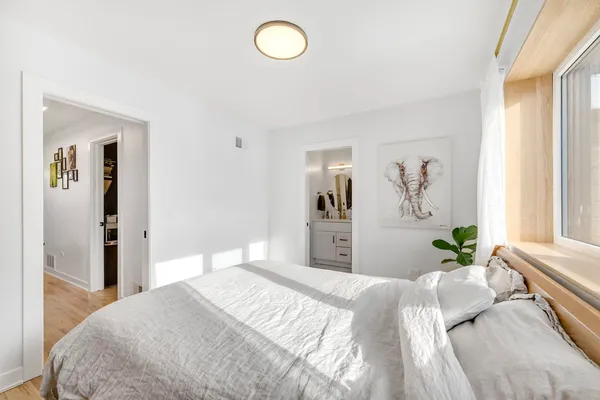 a bedroom with a bed and wooden floor