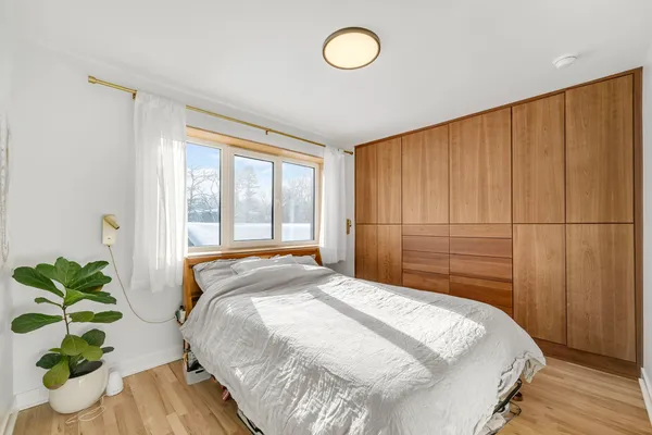 a spacious bedroom with a bed and a window