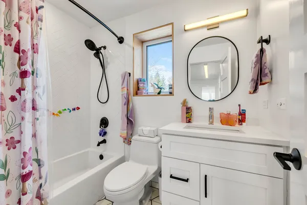 a bathroom with a sink a toilet and a mirror