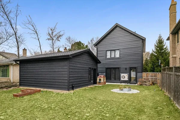 a view of a house with backyard and porch