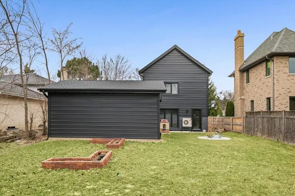 a small house with a wooden fence