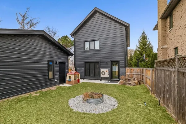 a backyard of a house with table and chairs