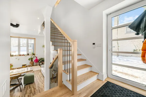 a view of entryway and hall with wooden floor