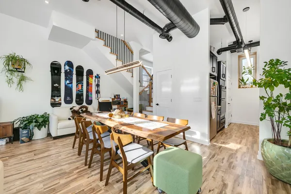 a view of a dining room with furniture and wooden floor
