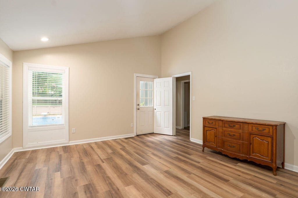 7 Timberlake Drive Jackson, TN 38305 - Photo 16 of 38 a view of an empty room with wooden floor and a window