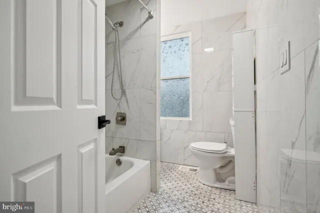 a bathroom with a toilet a sink and bathtub