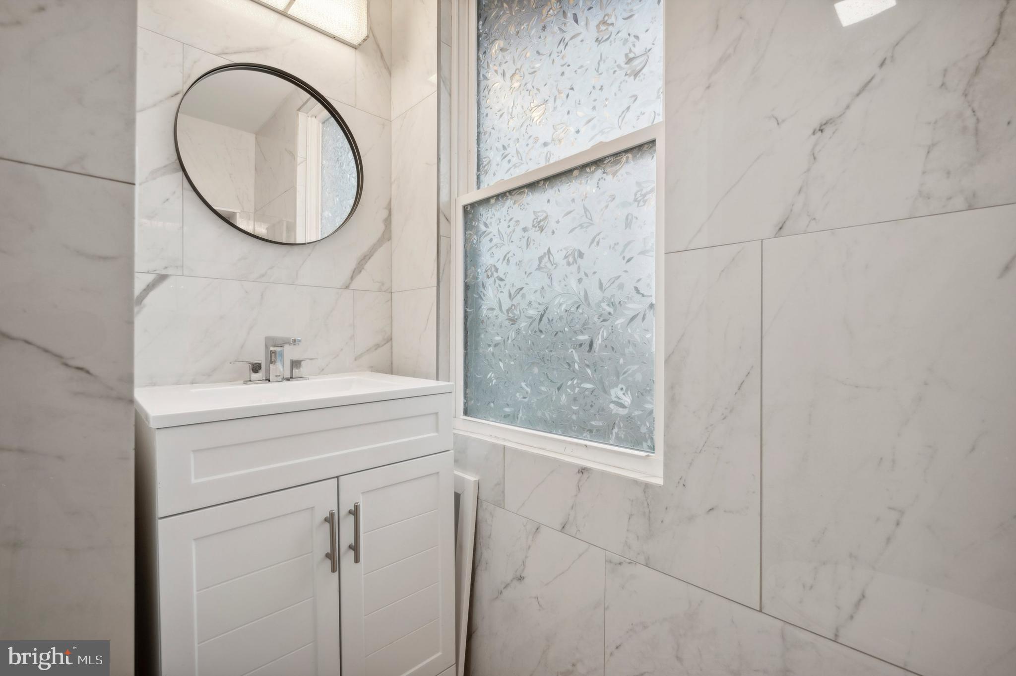 4520 Fernhill Road Philadelphia, PA 19144 - Photo 16 of 30 a bathroom with a sink and a mirror