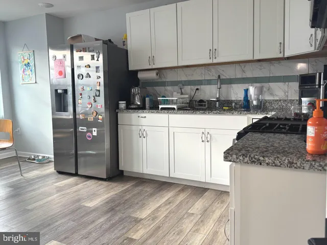 a kitchen with stainless steel appliances granite countertop a refrigerator sink and cabinets