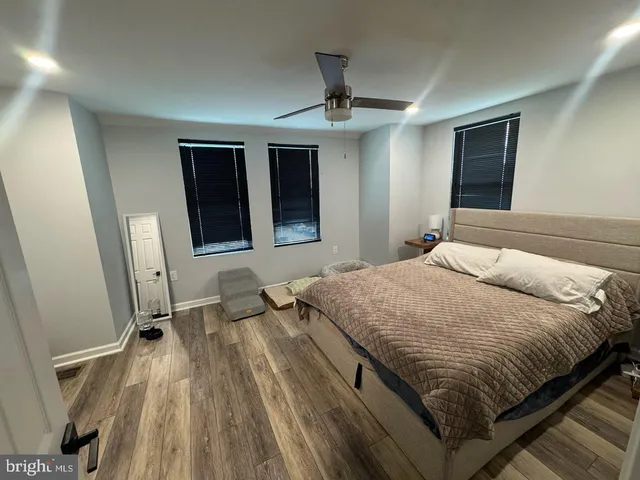 a bedroom with a bed and a mirror