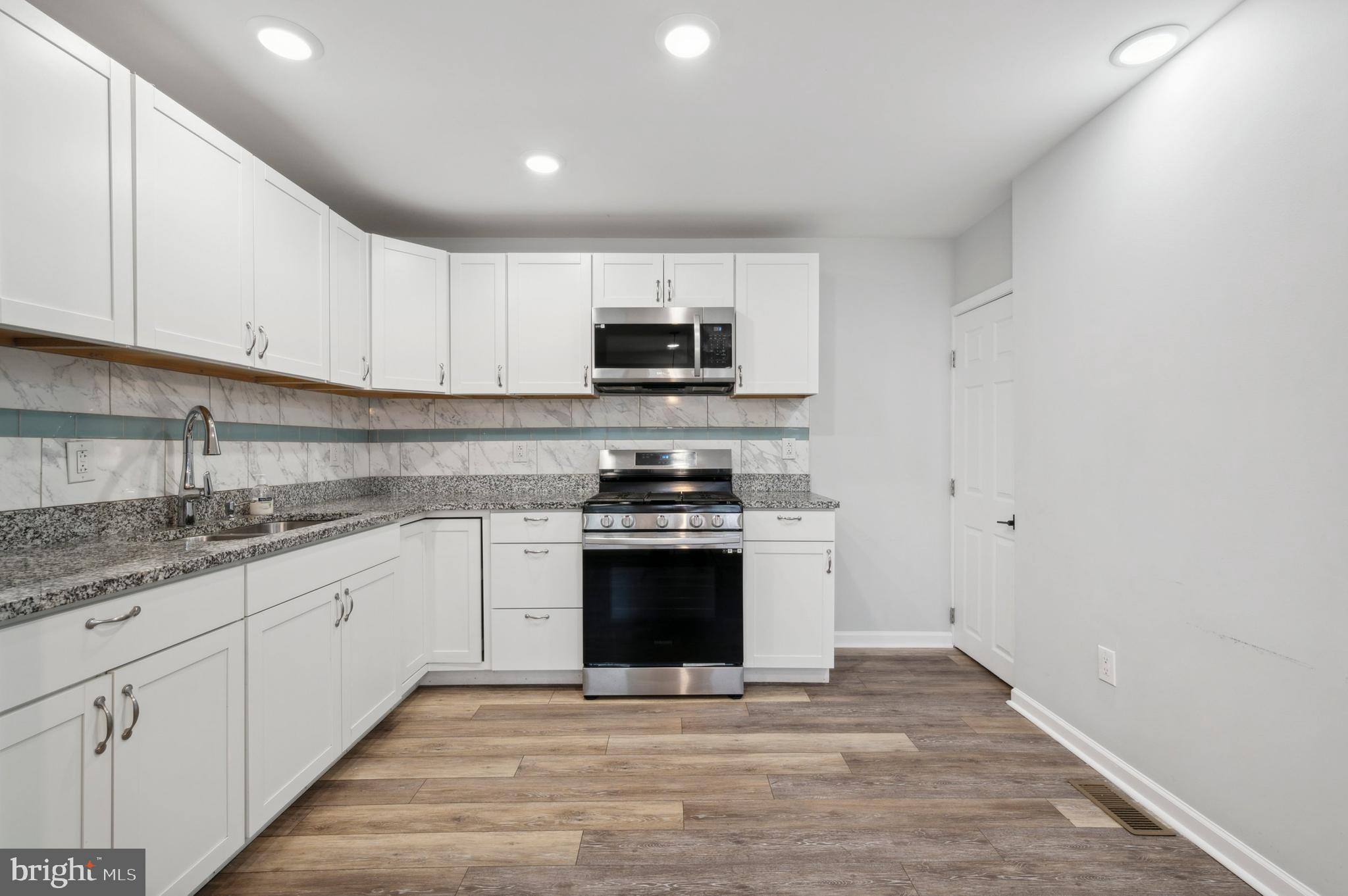 4520 Fernhill Road Philadelphia, PA 19144 - Photo 4 of 30 a kitchen with stainless steel appliances granite countertop a stove top oven a sink and dishwasher