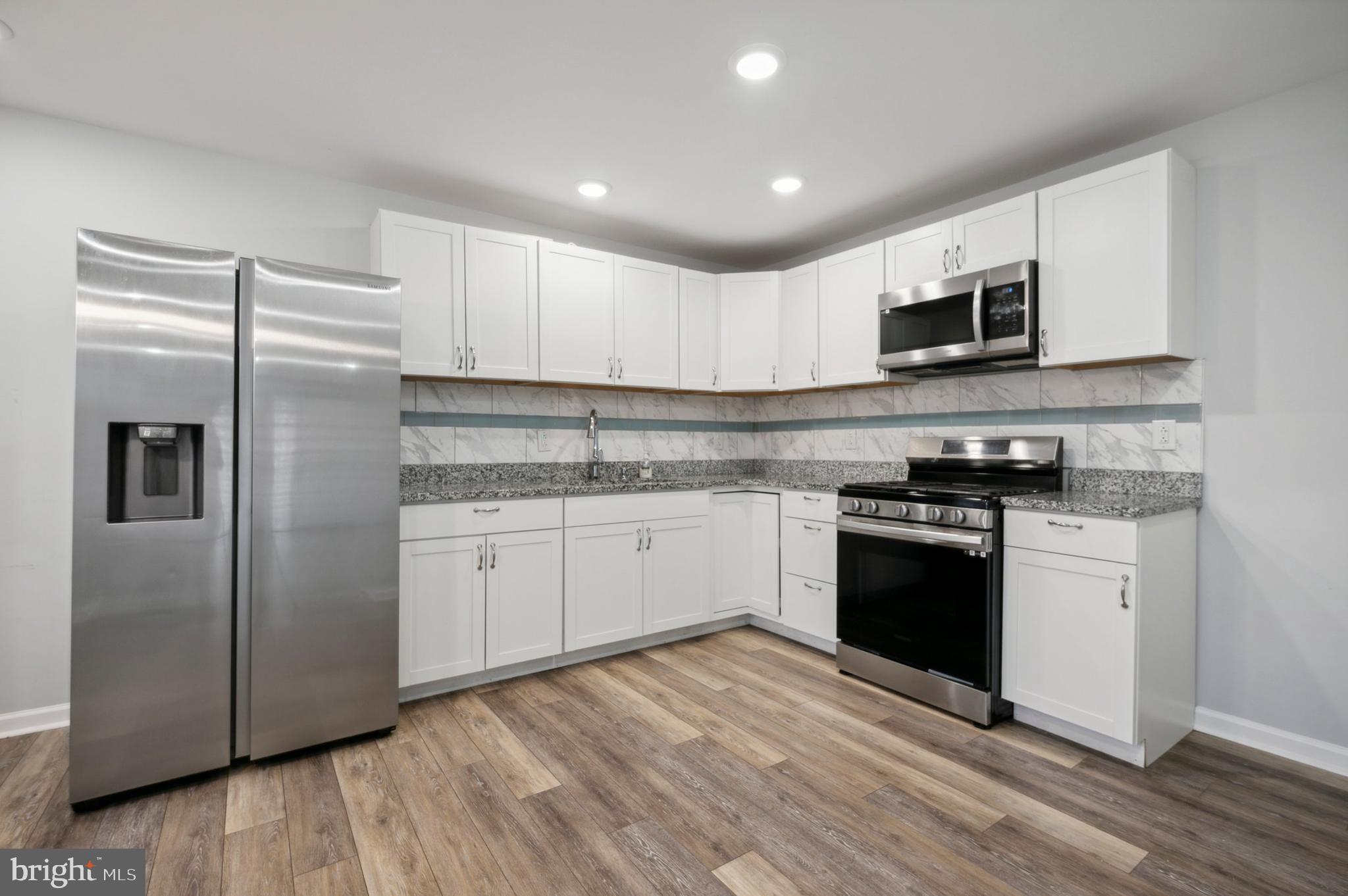 4520 Fernhill Road Philadelphia, PA 19144 - Photo 5 of 30 a kitchen with stainless steel appliances granite countertop a refrigerator and a stove top oven