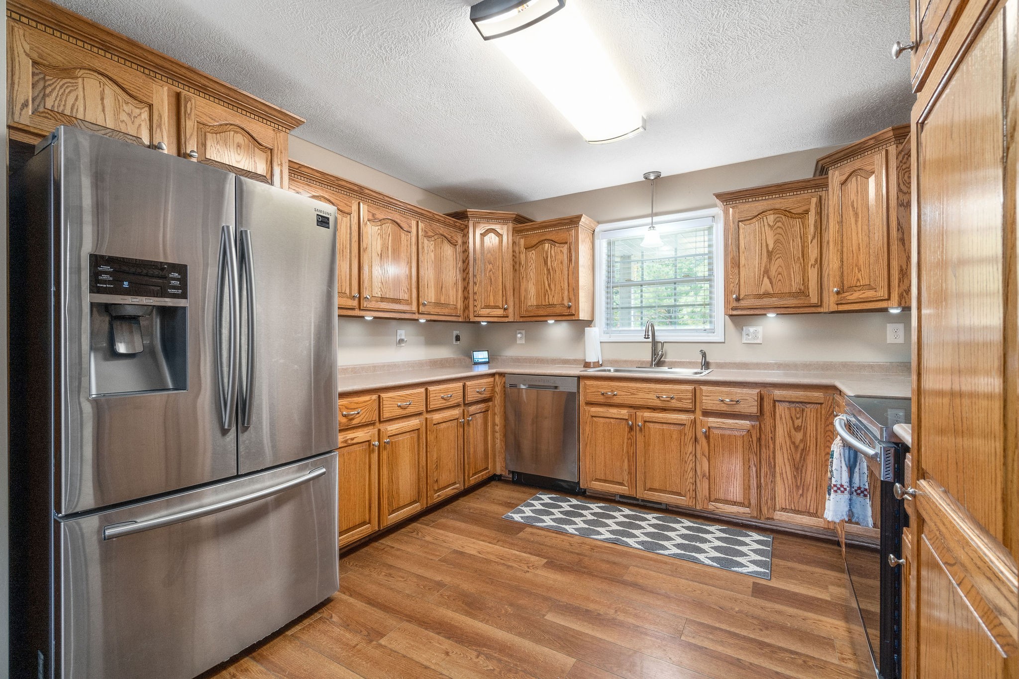 1216 Green Shanty Road Tennessee Ridge, TN 37178 - Photo 9 of 20 a kitchen with stainless steel appliances granite countertop a refrigerator stove microwave and sink