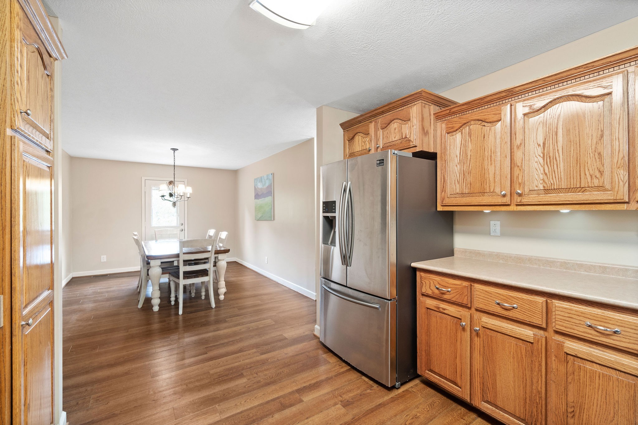1216 Green Shanty Road Tennessee Ridge, TN 37178 - Photo 10 of 20 a kitchen with stainless steel appliances granite countertop a refrigerator dining table and chairs
