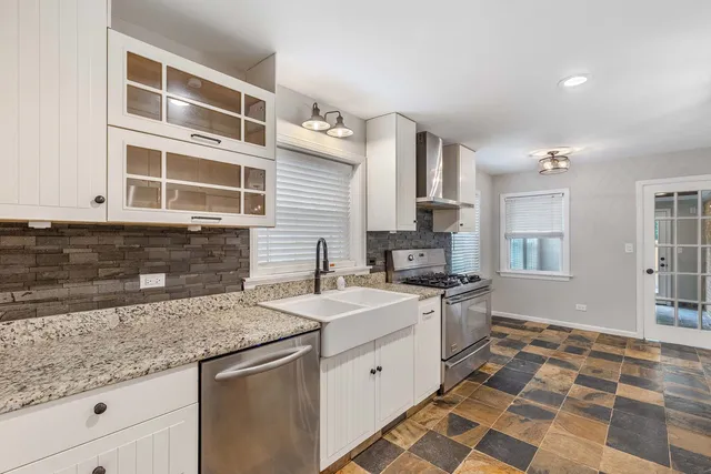 a kitchen that has a sink and a stove