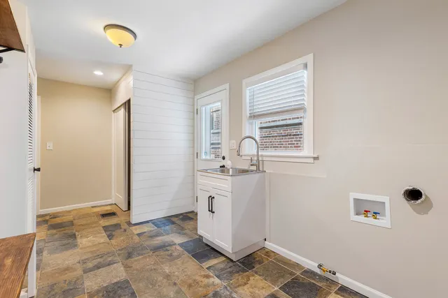 a view of a storage & utility room with a window