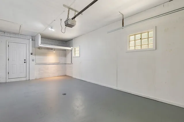 a view of empty room with wooden floor and windows