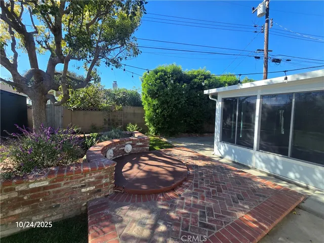 a view of a backyard with plants and a patio