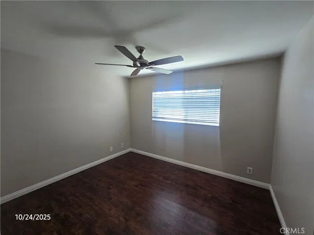 a view of a big room with wooden floor closet and windows