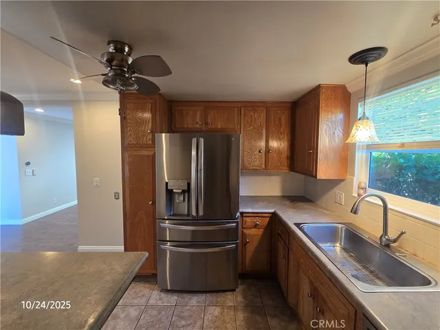 a kitchen with stainless steel appliances granite countertop a sink a refrigerator and a granite counter tops